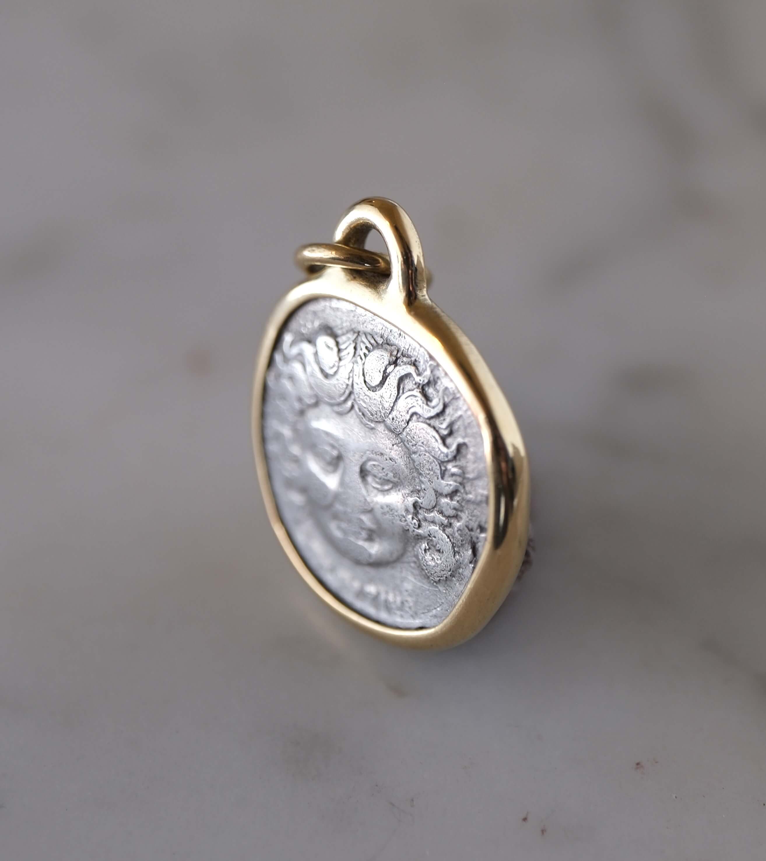 Medusa and Aurora Hand Set in a Custom 18k Gold Bezel